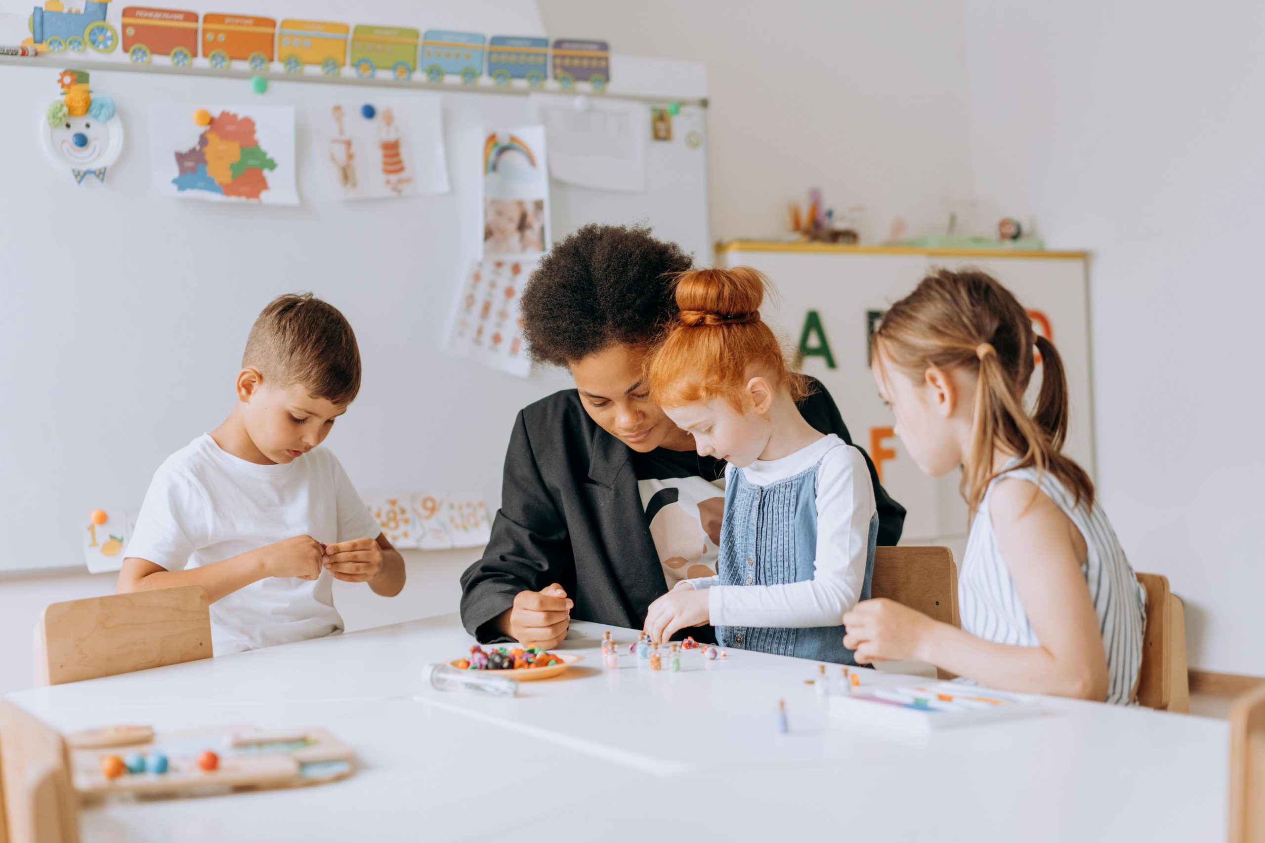 A group of children studying and playing in a diverse and inclusive classroom setting.