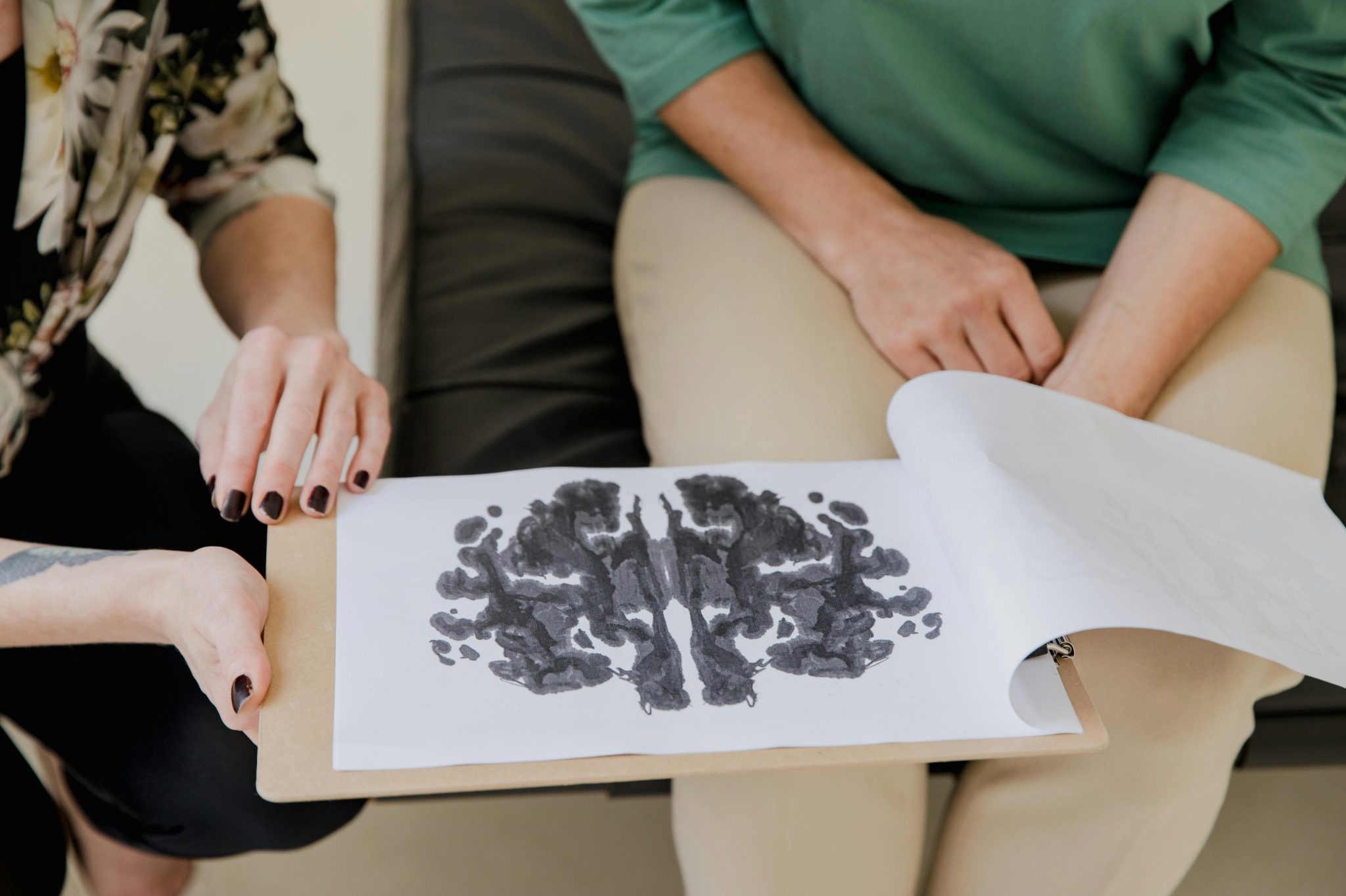 A close-up of a Rorschach inkblot test during a psychotherapy session, highlighting mental health care.